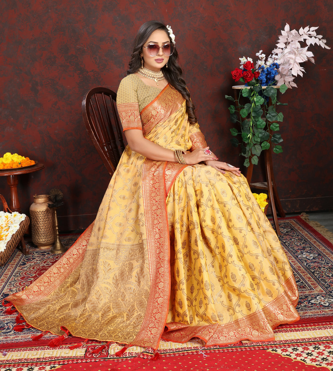 Timeless yellow Katan silk saree featuring intricate zari work and a tasseled pallu, perfect for formal events.