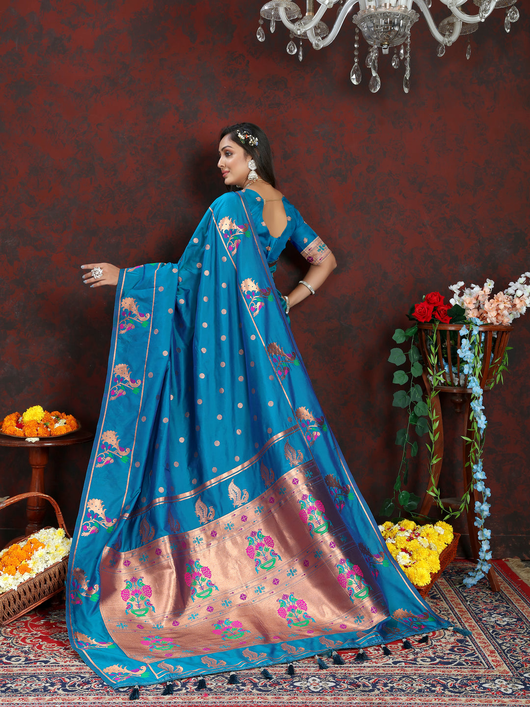 Traditional blue Paithani silk saree with beautiful copper zari motifs and Meenakari border for cultural events.