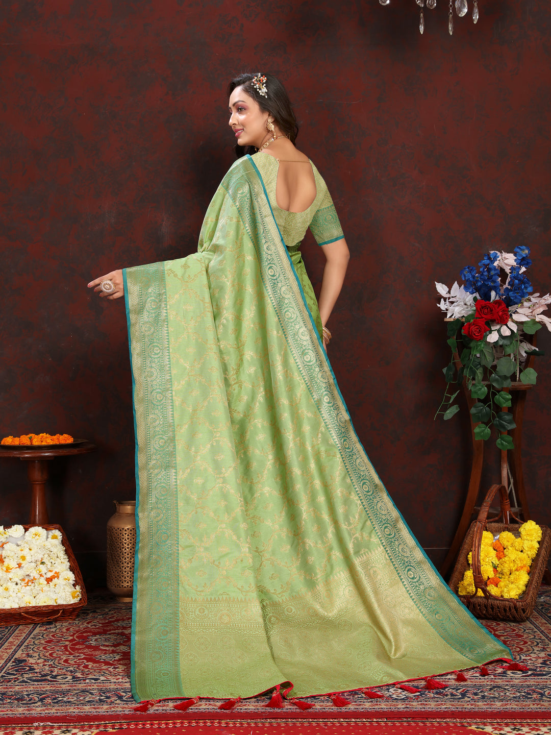 Stunning pista green Katan silk saree with intricate zari work, complete with a matching blouse piece.