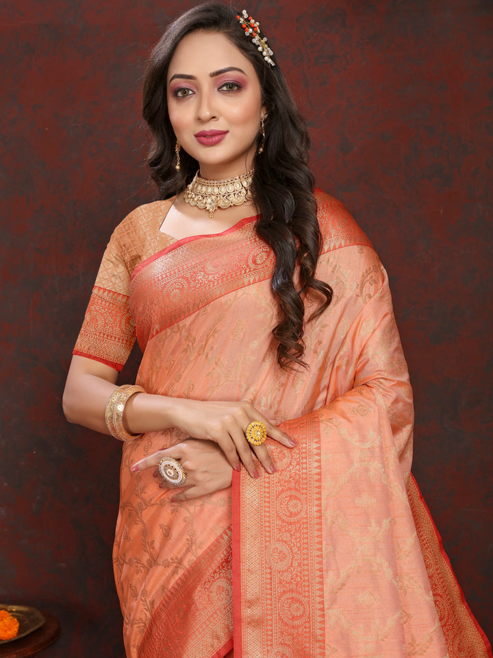 Graceful peach soft Katan silk saree featuring exquisite zari work and a matching blouse piece.