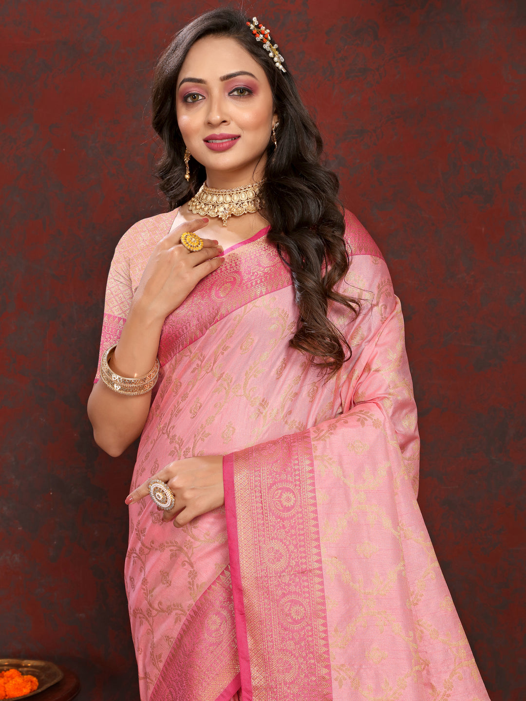 Elegant pink soft Katan silk saree with detailed zari weaving and a matching blouse piece.