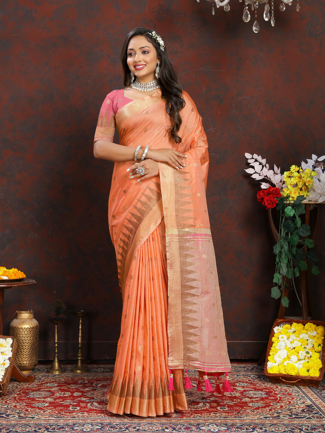 Elegant Orange Silk Saree featuring intricate zari weaving and a designer pallu with tassels.