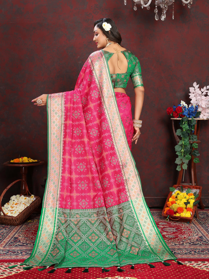 Radiant Coral-Pink Patola Silk Saree with intricate meenakari details and dreamy pallu style for celebrations.