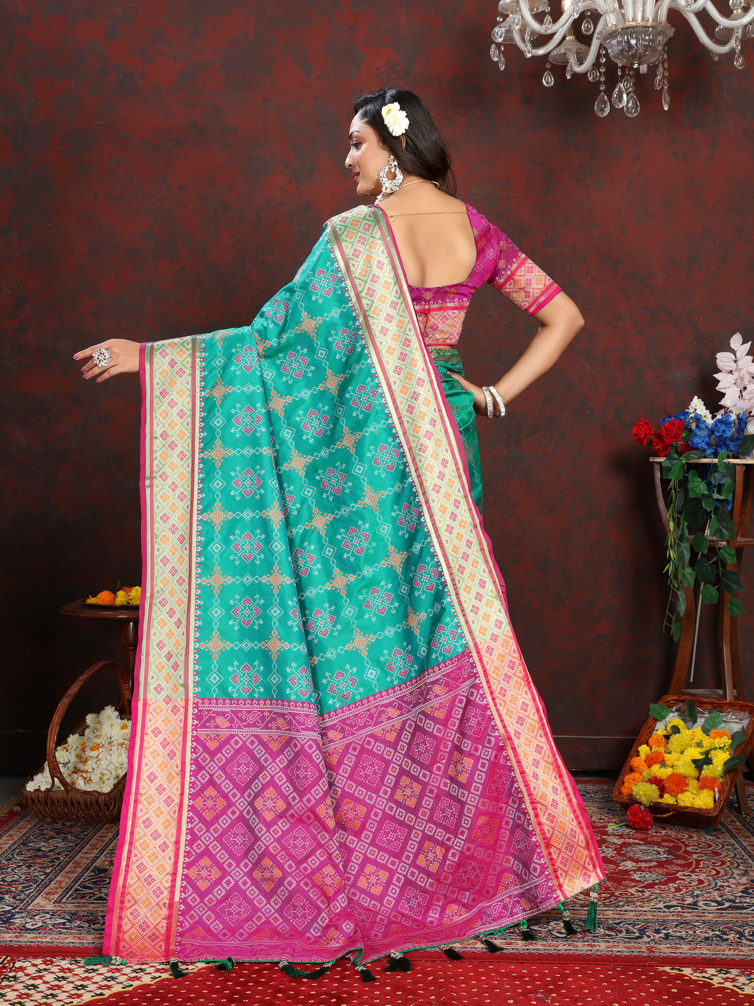 Beautiful Sea-Green Patola Silk Saree with intricate meenakari work and stylish pallu for bridal wear.