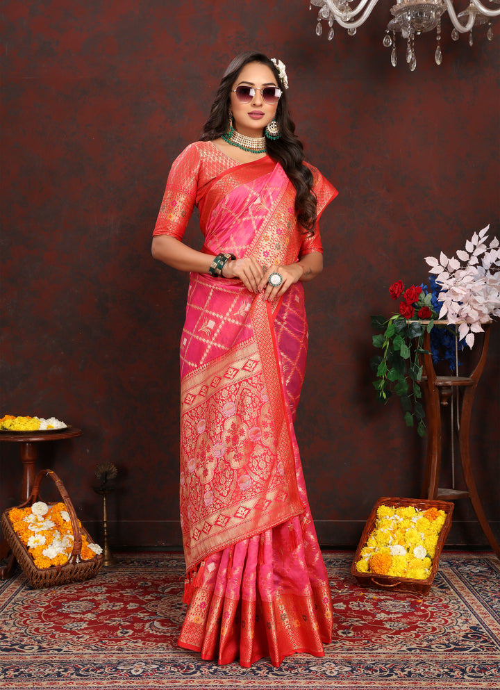 Bright pink Organza silk sari with stunning detail, perfect for festive Indian celebrations.