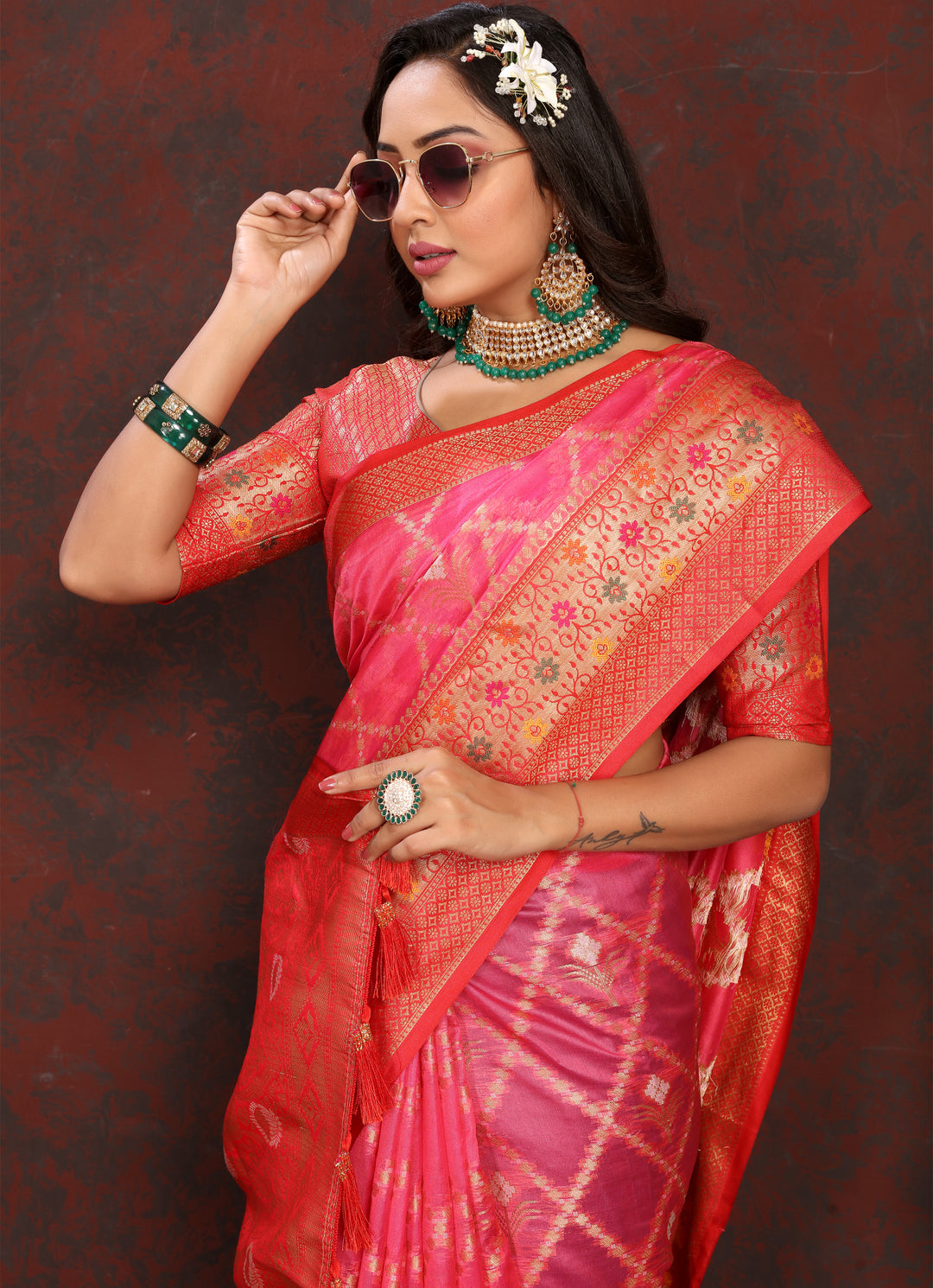 Elegant bright pink Organza silk sari with luxurious detail and matching blouse, ideal for cultural events.