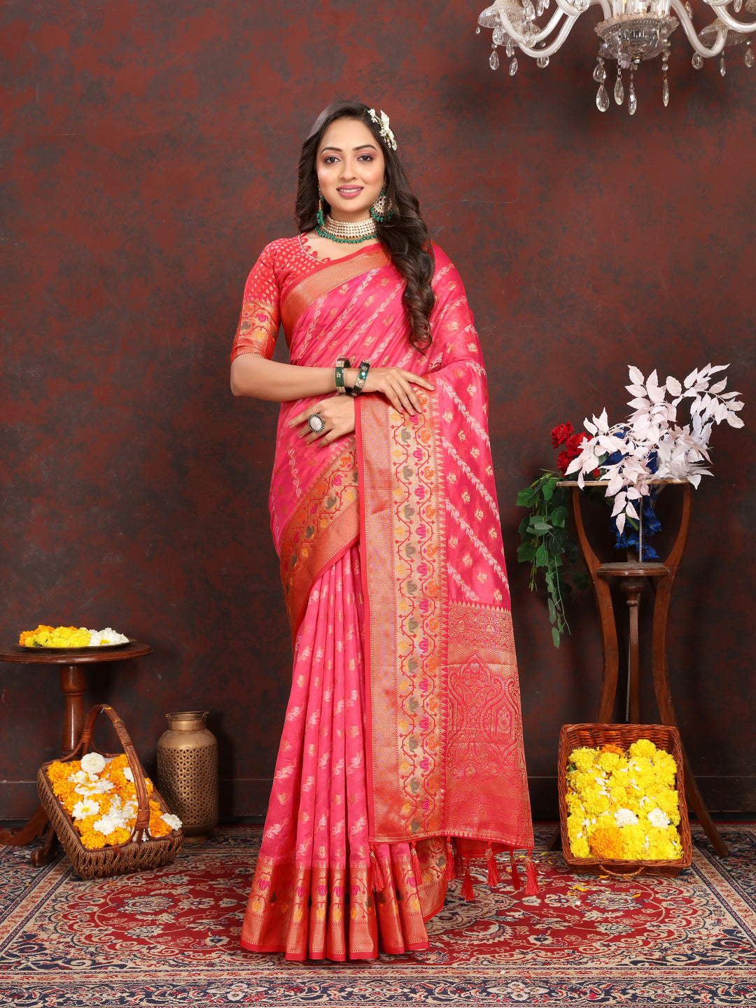 Elegant red organza saree with intricate designs, complemented by a matching blouse piece, perfect for festive occasions.