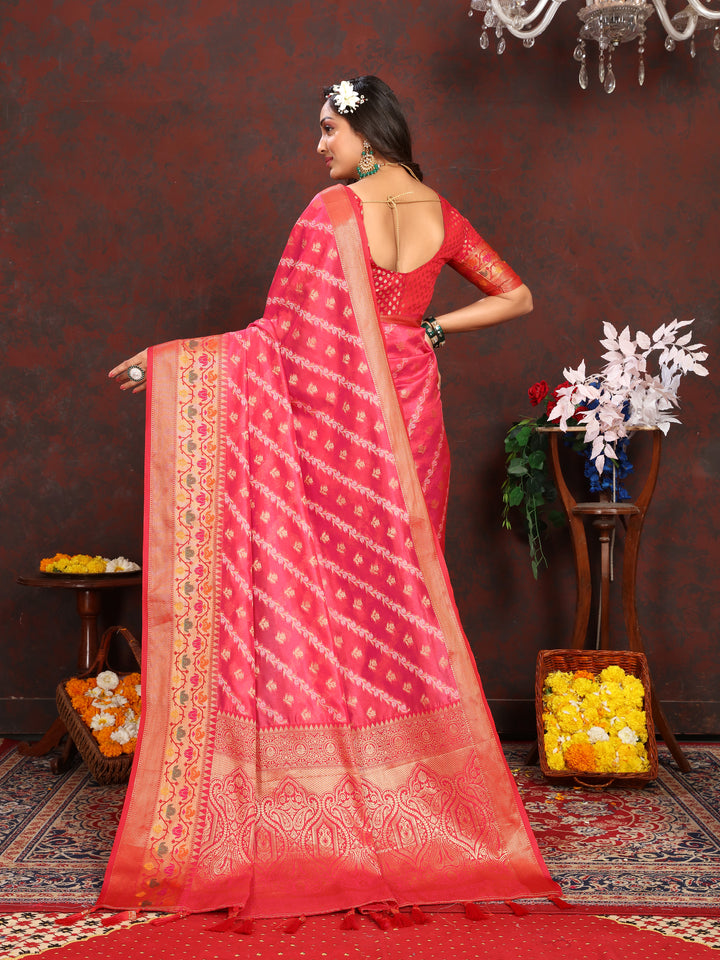 Beautiful red organza saree featuring intricate designs and a perfectly matched blouse piece, ideal for festive wear.