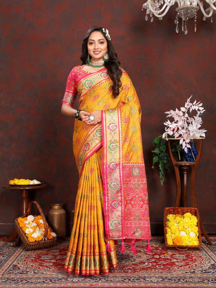 Elegant Mustard-Yellow Patola Silk Saree with meenakari motifs and a designer blouse for festive occasions.