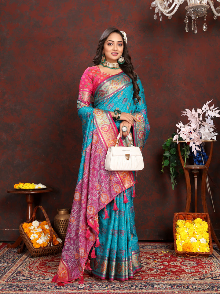 Radiant Sea-Blue Patola Silk Saree with meenakari details and designer blouse for festive celebrations.