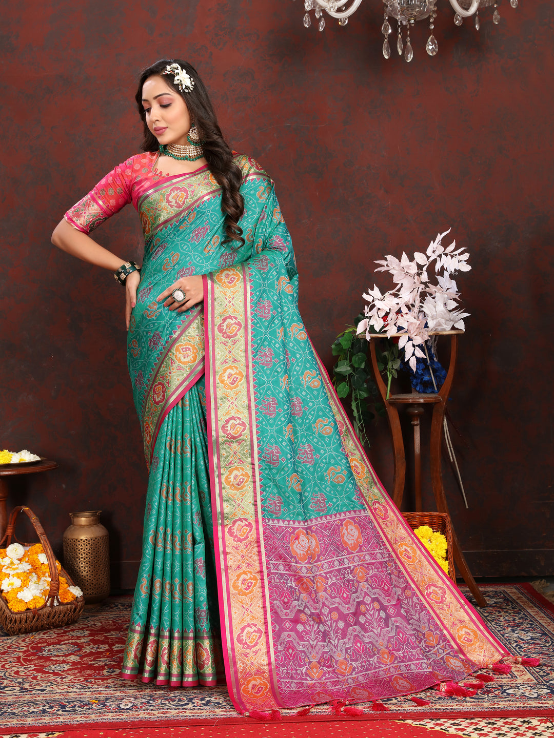 Elegant Sea-Green Patola Silk Saree with exquisite meenakari motifs and a stylish designer blouse for festive wear.