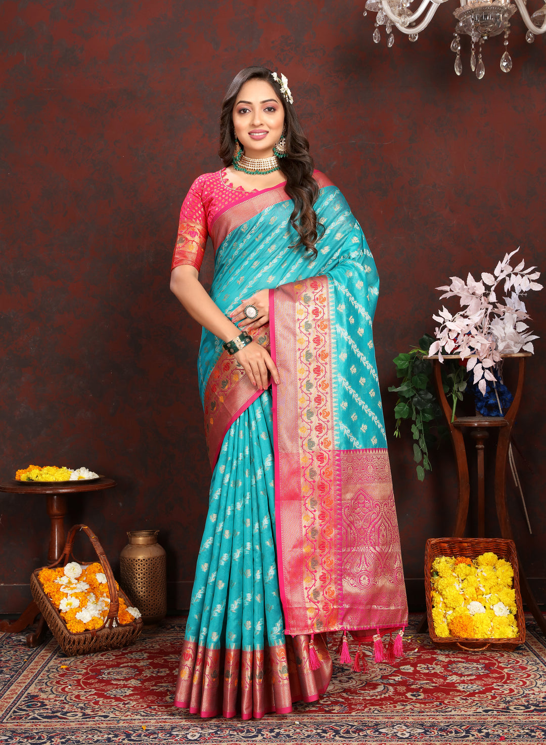 Beautiful sea blue organza saree with delicate embroidery, complemented by a matching blouse piece for festive occasions.