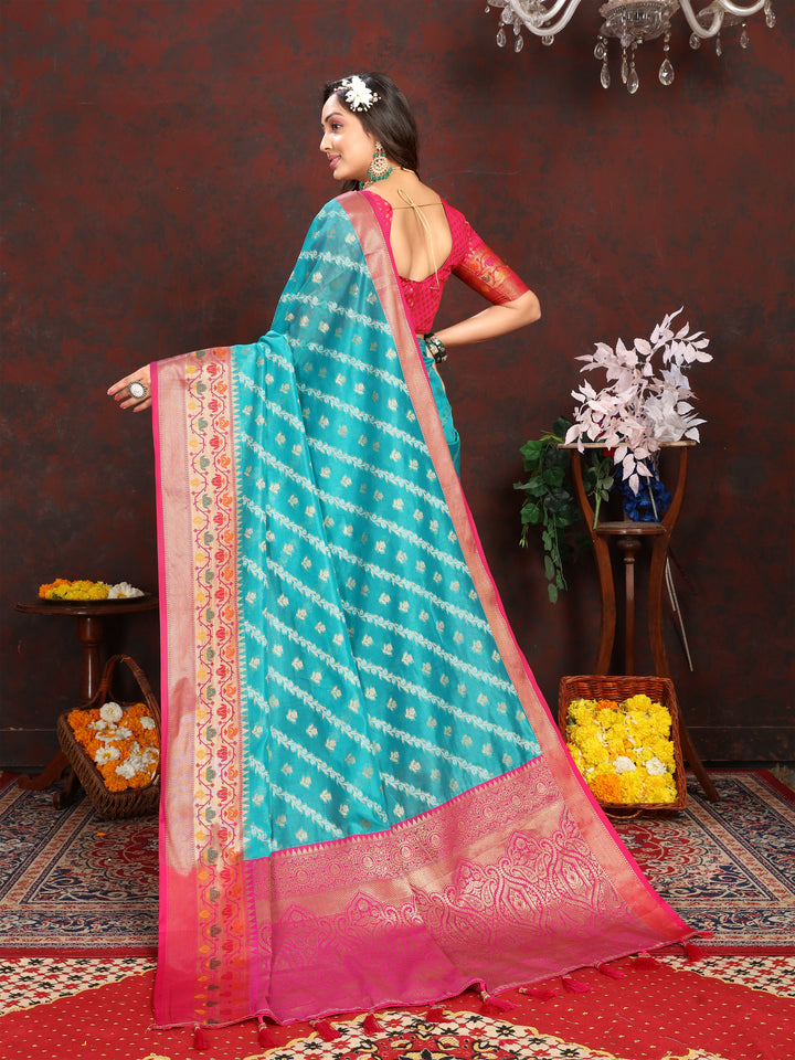 Stunning sea blue organza saree featuring delicate embroidery and a matching blouse piece, ideal for cultural celebrations.