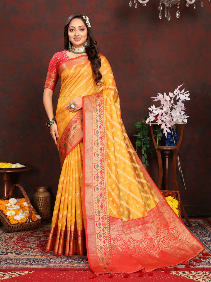 Stunning yellow soft organza saree with graceful patterns and matching blouse piece, ideal for festive celebrations.