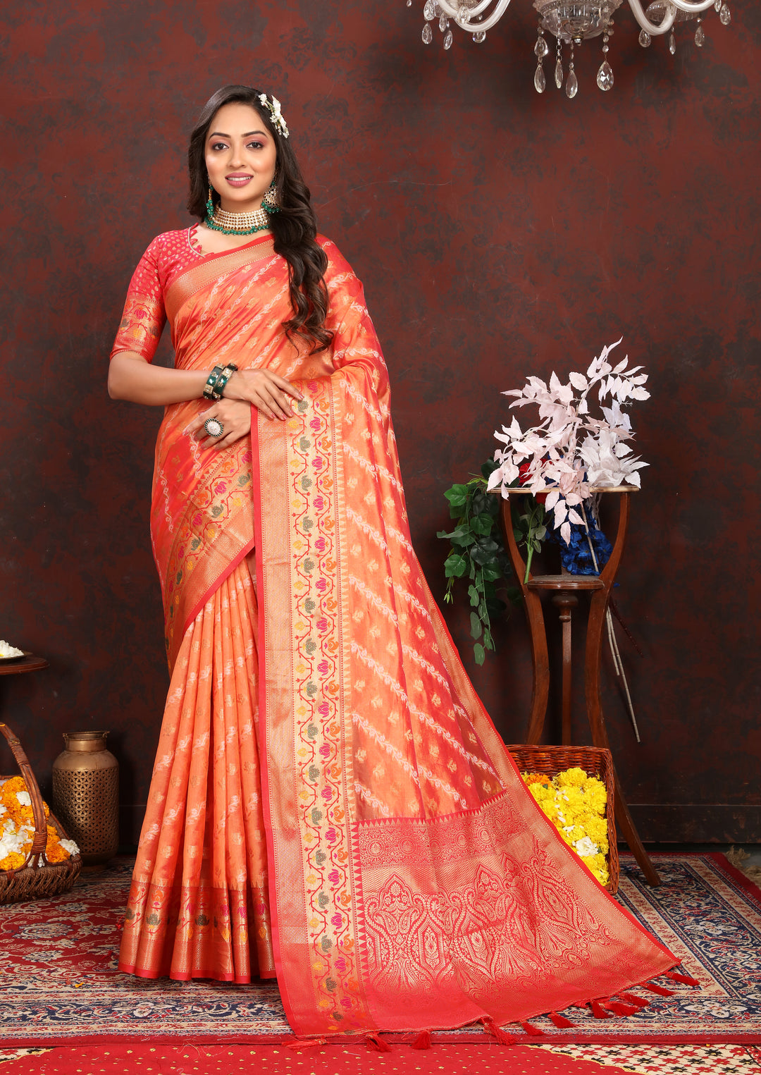 Stunning orange organza saree with intricate embroidery, paired with a matching blouse piece, perfect for festive occasions.