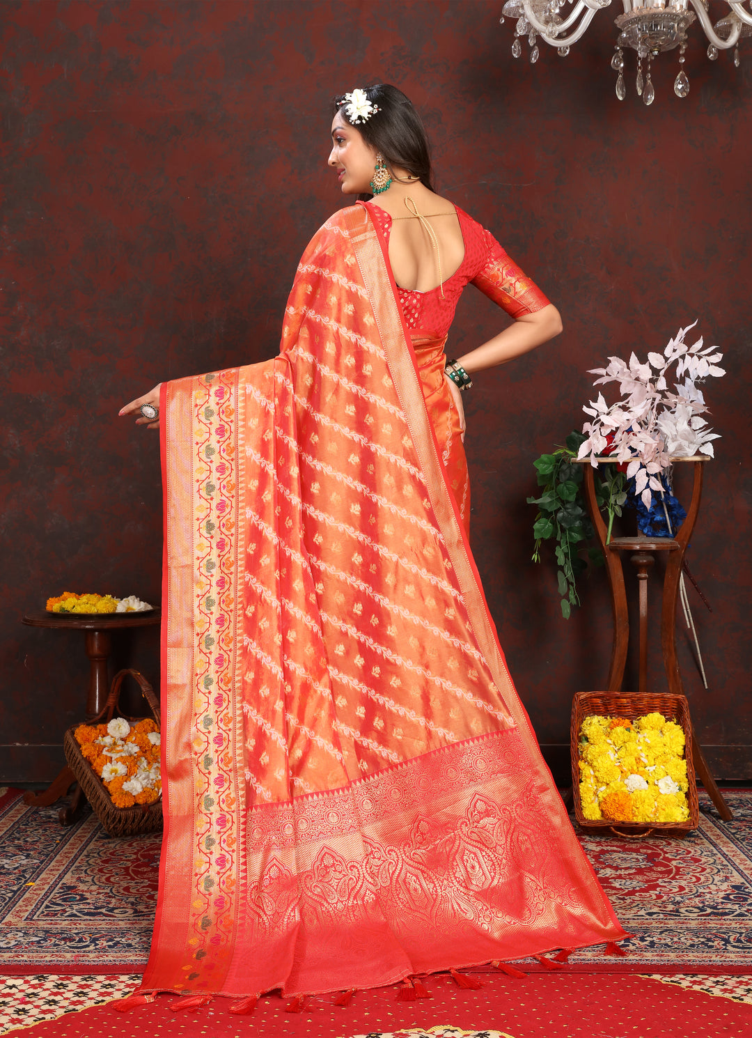 Gorgeous orange organza saree with graceful detailing and matching blouse piece, ideal for traditional celebrations.