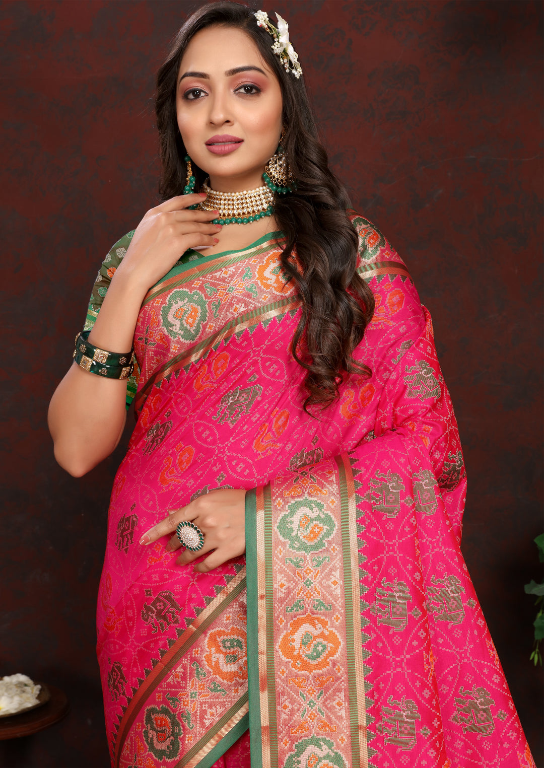 Stunning Pink Patola Silk Saree with meenakari motifs and a luxurious designer blouse for festive occasions.