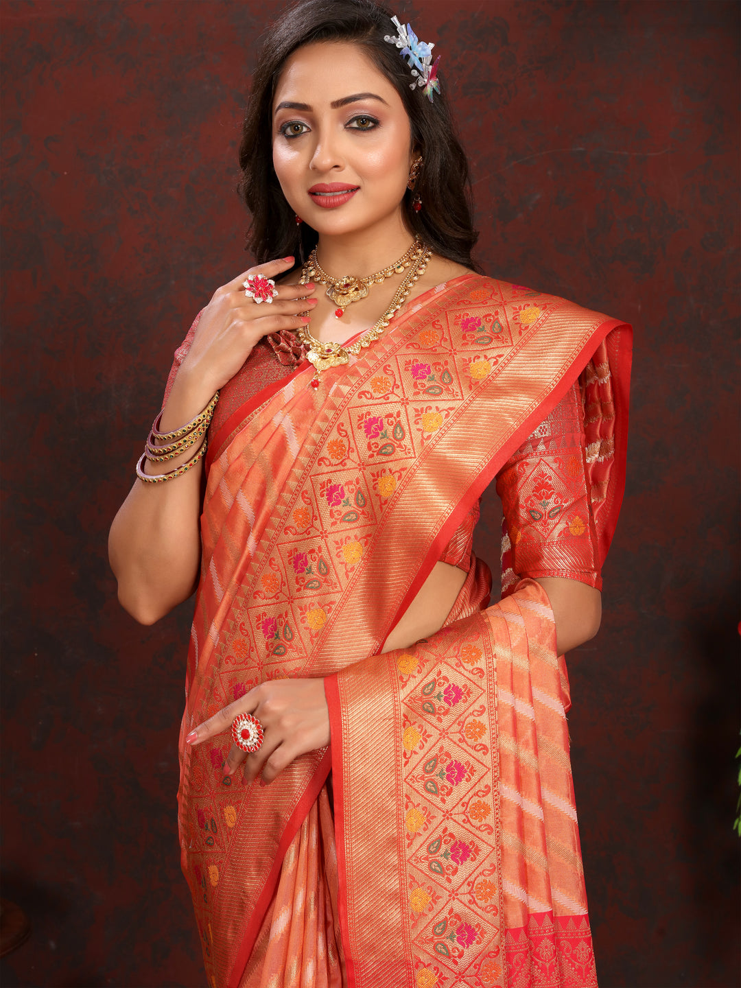 Elegant Orange Organza Saadi featuring beautiful patterns and luxurious embroidery for festive occasions.