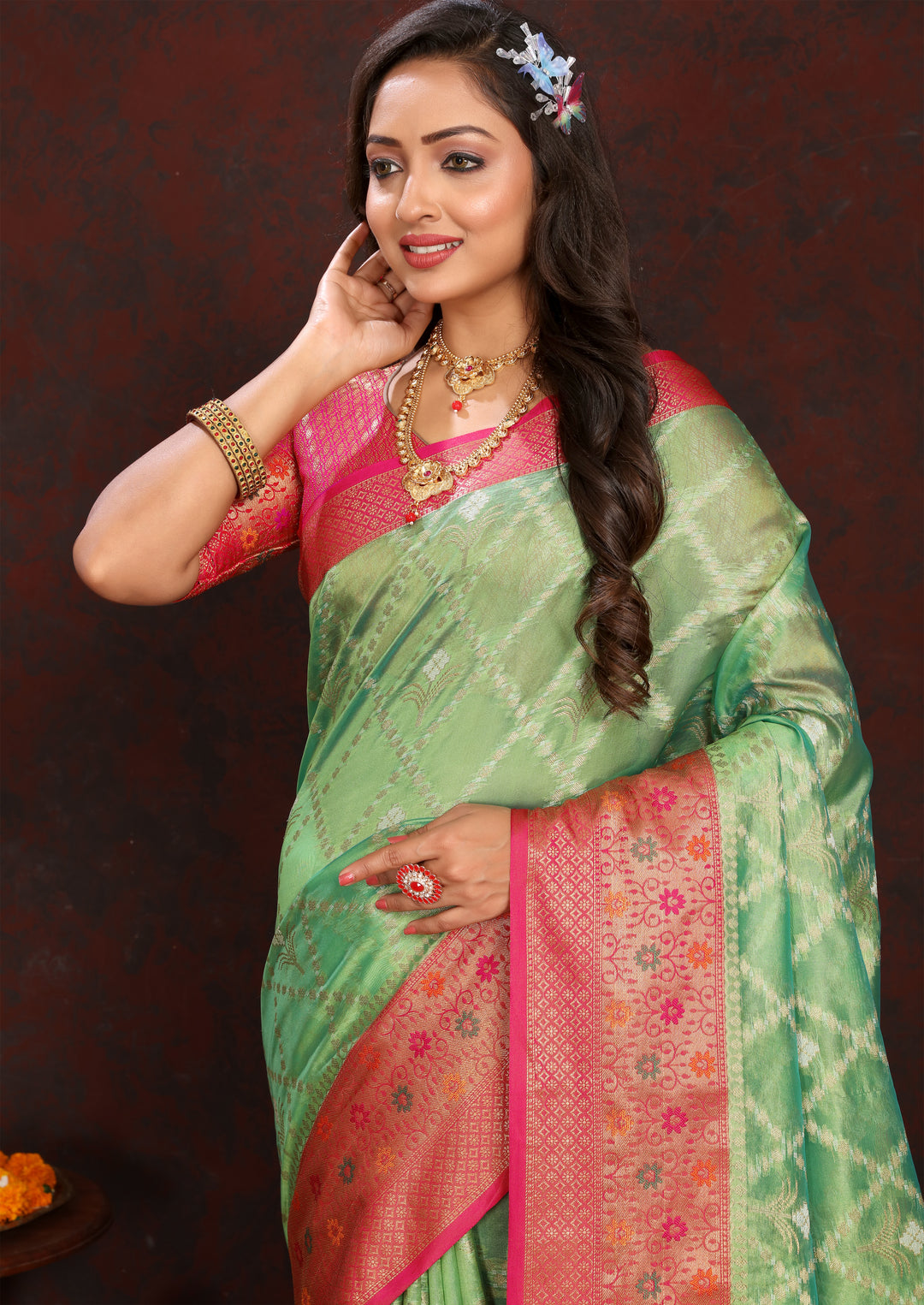 Elegant green Organza sari with beautiful detail and matching blouse, ideal for weddings.