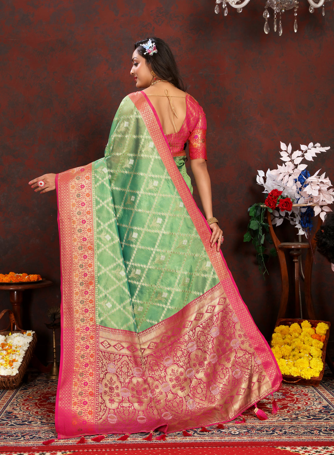 Sophisticated green Organza sari with luxurious detail, paired with a matching blouse for Indian celebrations.