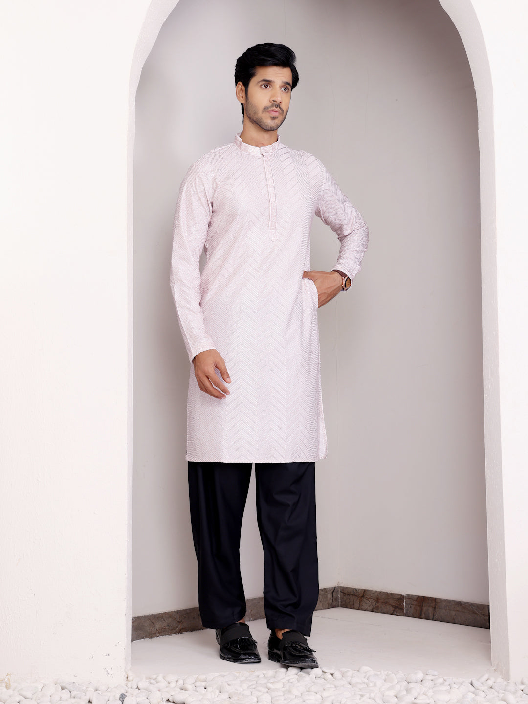 Light pink kurta set for men with sophisticated Chikankari detailing and handwoven motifs for festive wear.