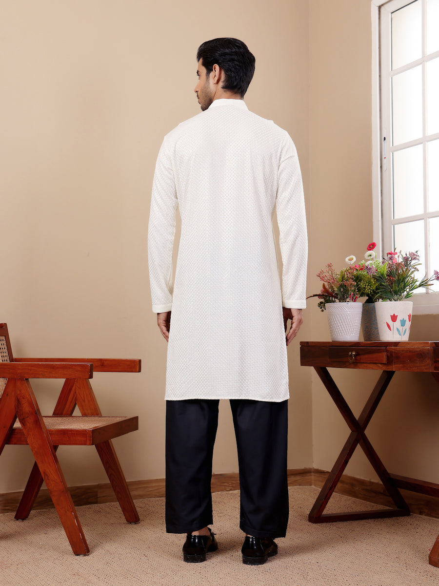 White kurta set for men with intricate handwoven motifs and Chikankari embroidery.