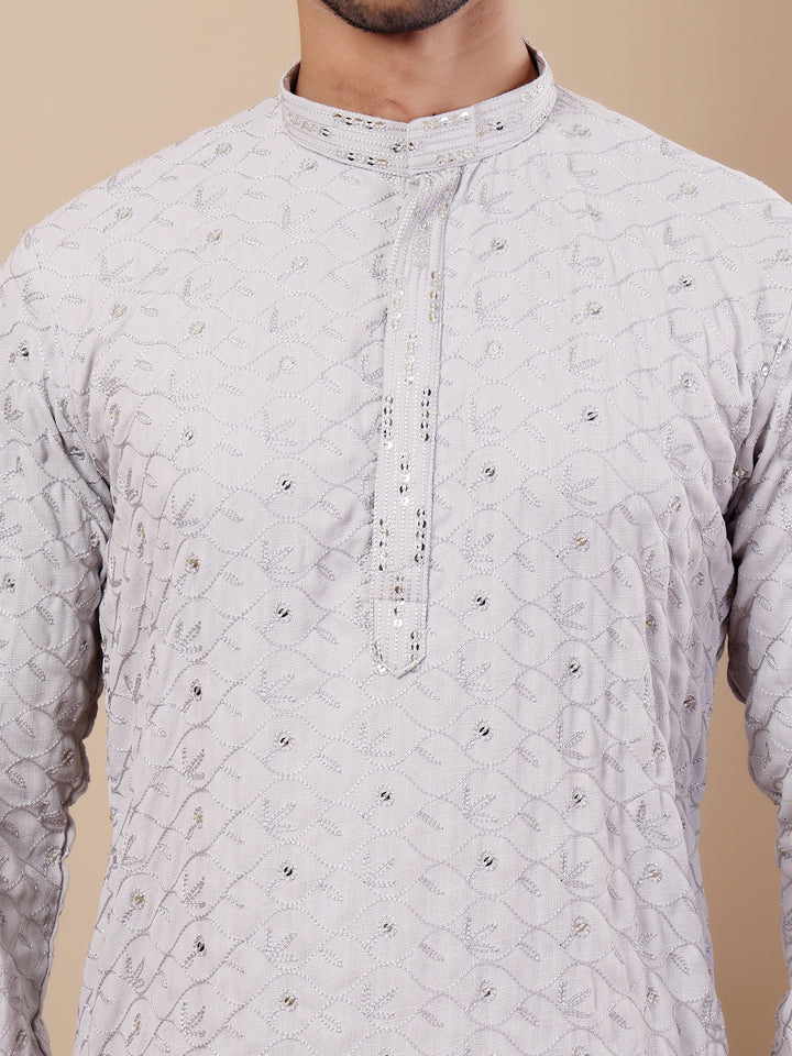 Luxurious men's cotton kurta set with intricate weaving, perfect for festivals and formal gatherings.