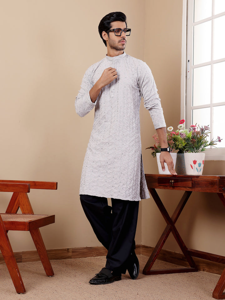 Ethnic men's kurta set with premium cotton fabric and unique woven motifs for special events.