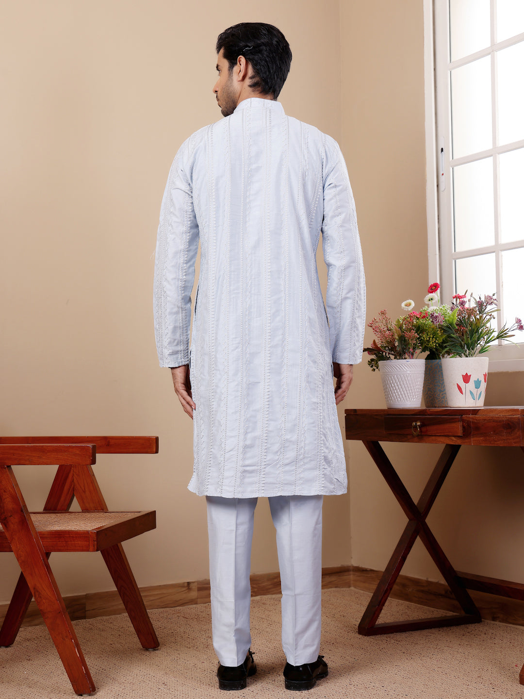 Traditional light blue cotton kurta set showcasing handcrafted motif detailing.