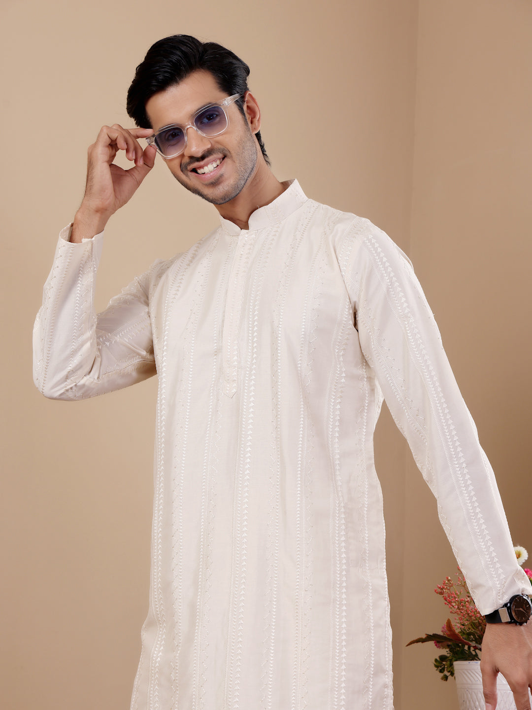 Traditional off-white kurta set featuring handcrafted details on the neckline.