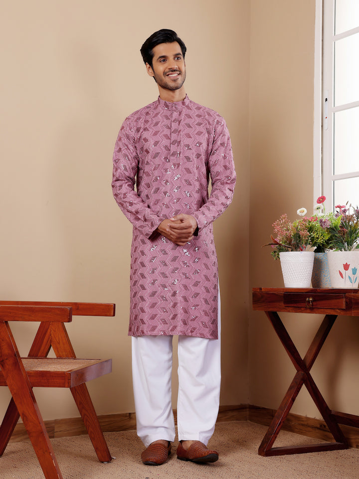 Pinkish purple kurta pajama for men with Chikankari embroidery for weddings and events.