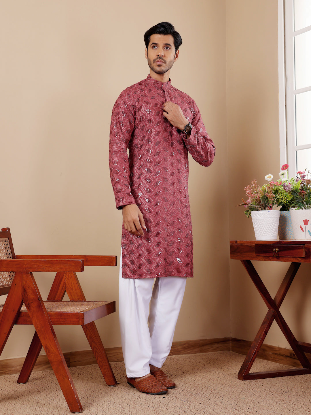 Sophisticated barry red kurta with floral Chikankari embroidery and art silk bottoms.