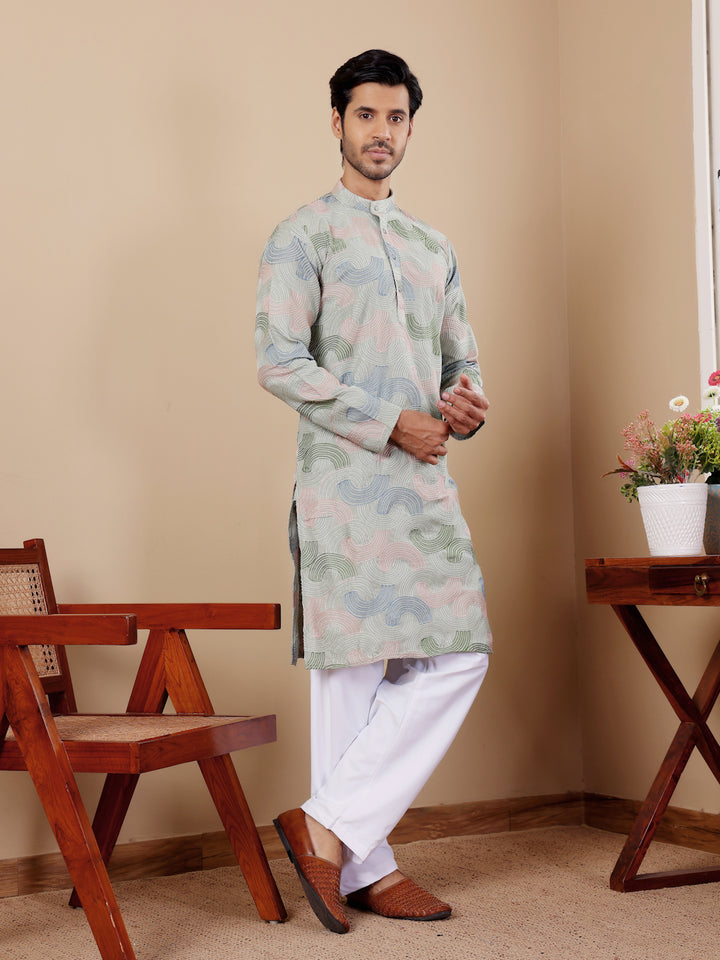 Festive men's kurta with intricate embroidery on neckline and cuffs.