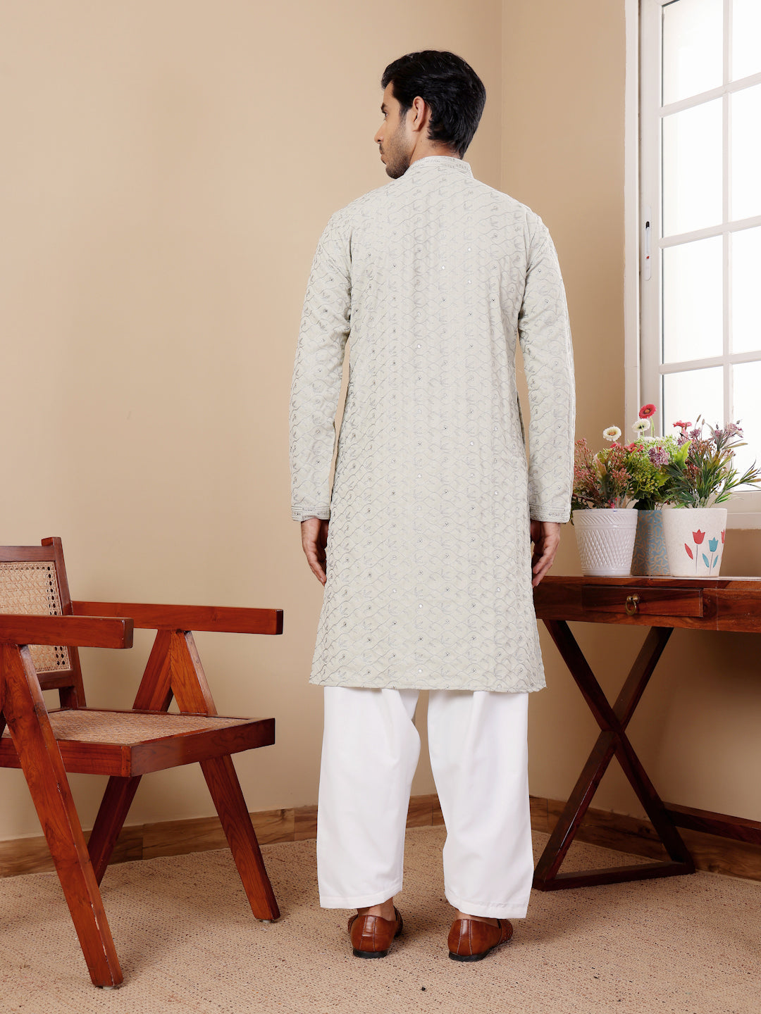 Classic men's kurta pajama set with intricate motifs for a luxury festive touch.