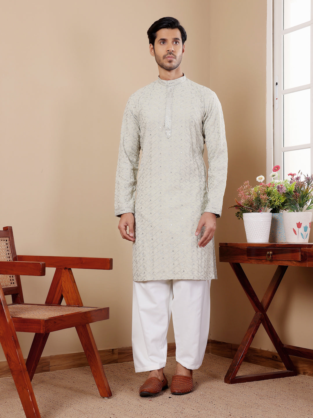 Elegant men's kurta pajama with intricate weaved motifs for modern style and traditional grace.