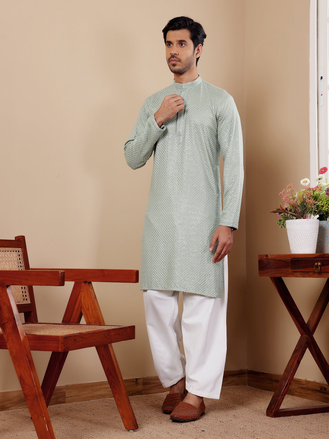 Men’s light pastel green kurta featuring Chikankari embroidery and luxurious art silk bottoms.