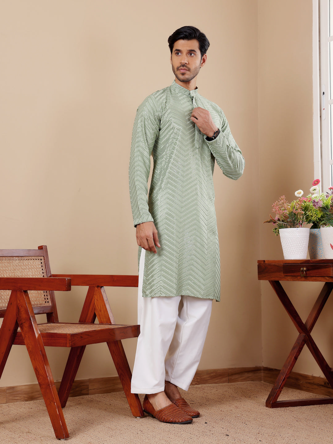 Pastel green kurta set with fine Chikankari embroidery and handwoven detailing, perfect for cultural events.