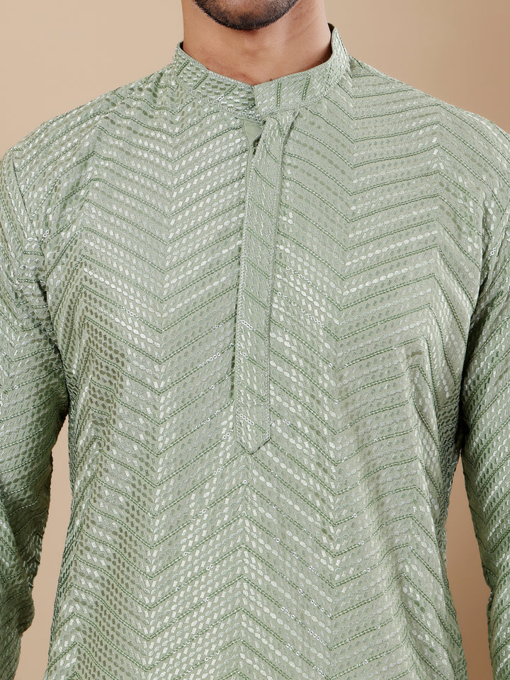 Timeless pastel green kurta set for men with intricate Chikankari work and handwoven motifs.