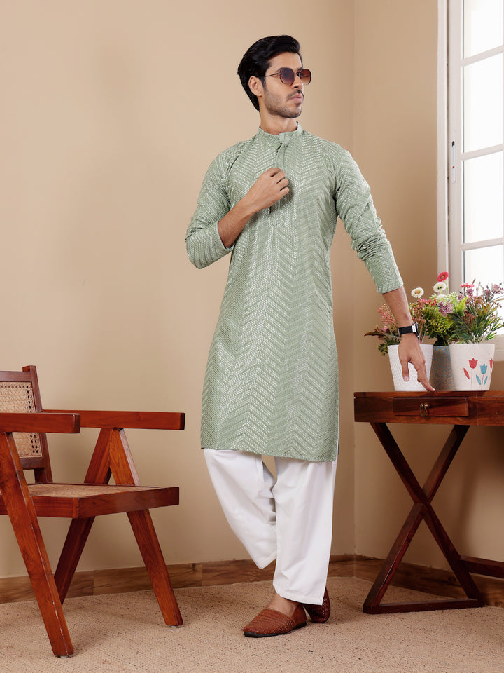 Pastel green kurta set for men with handwoven motifs and Chikankari detailing, ideal for formal gatherings.