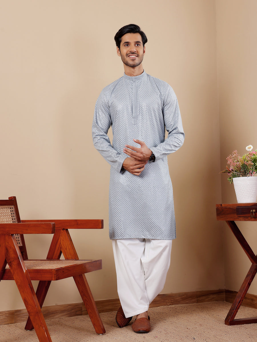 Baby blue kurta set for men with intricate Chikankari embroidery and art silk bottoms.