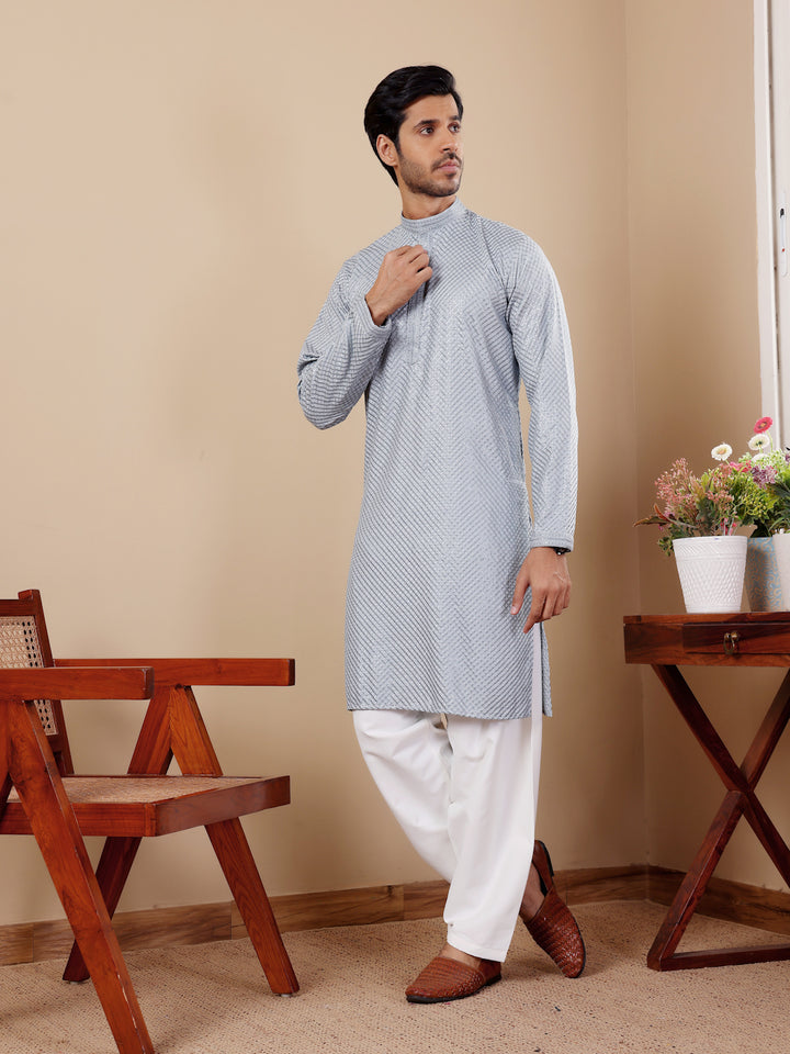 Timeless baby blue kurta for men featuring delicate Chikankari work and luxurious art silk bottoms.