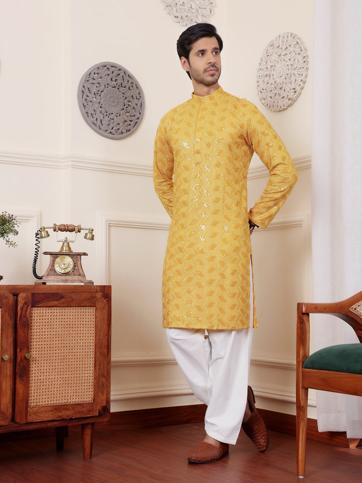 Yellow kurta with intricate Chikankari embroidery and art silk bottoms for men.