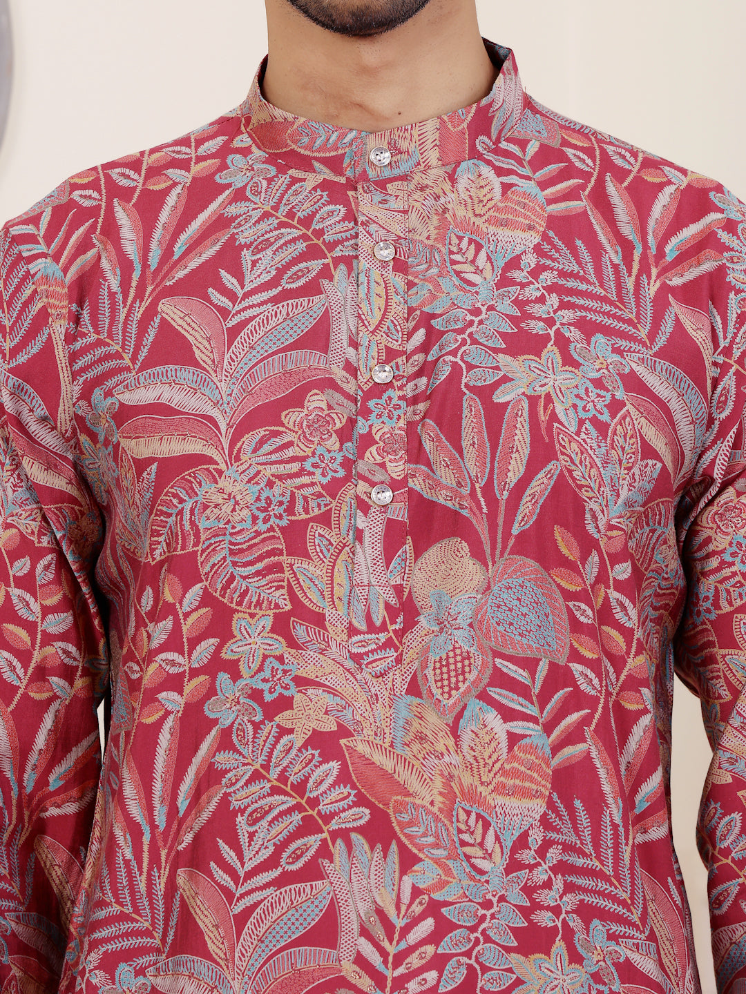 Luxurious pink kurta set for men with embroidered neckline and sleeves
