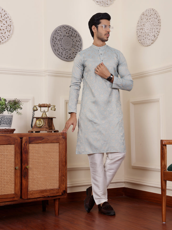 Stylish light blue kurta for men with detailed beige motifs, perfect for various occasions.