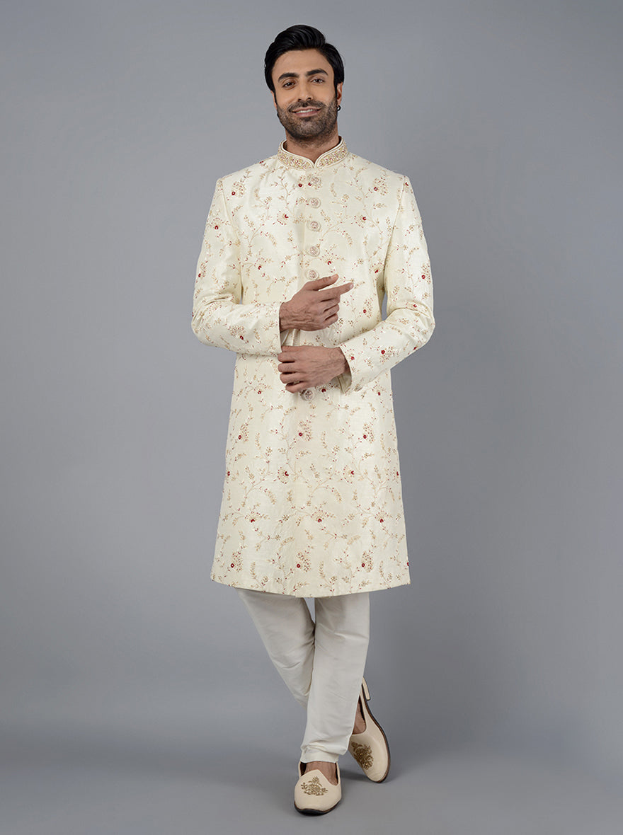 Crafted from luxurious silk blend fabric, this traditional Indian sherwani features exquisite resham and tar work.