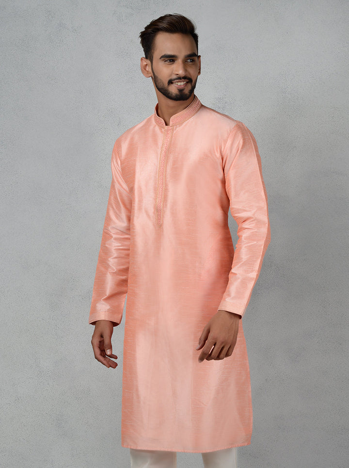 Elevate your festive wardrobe with this exquisite peach kurta set designed for modern celebrations.