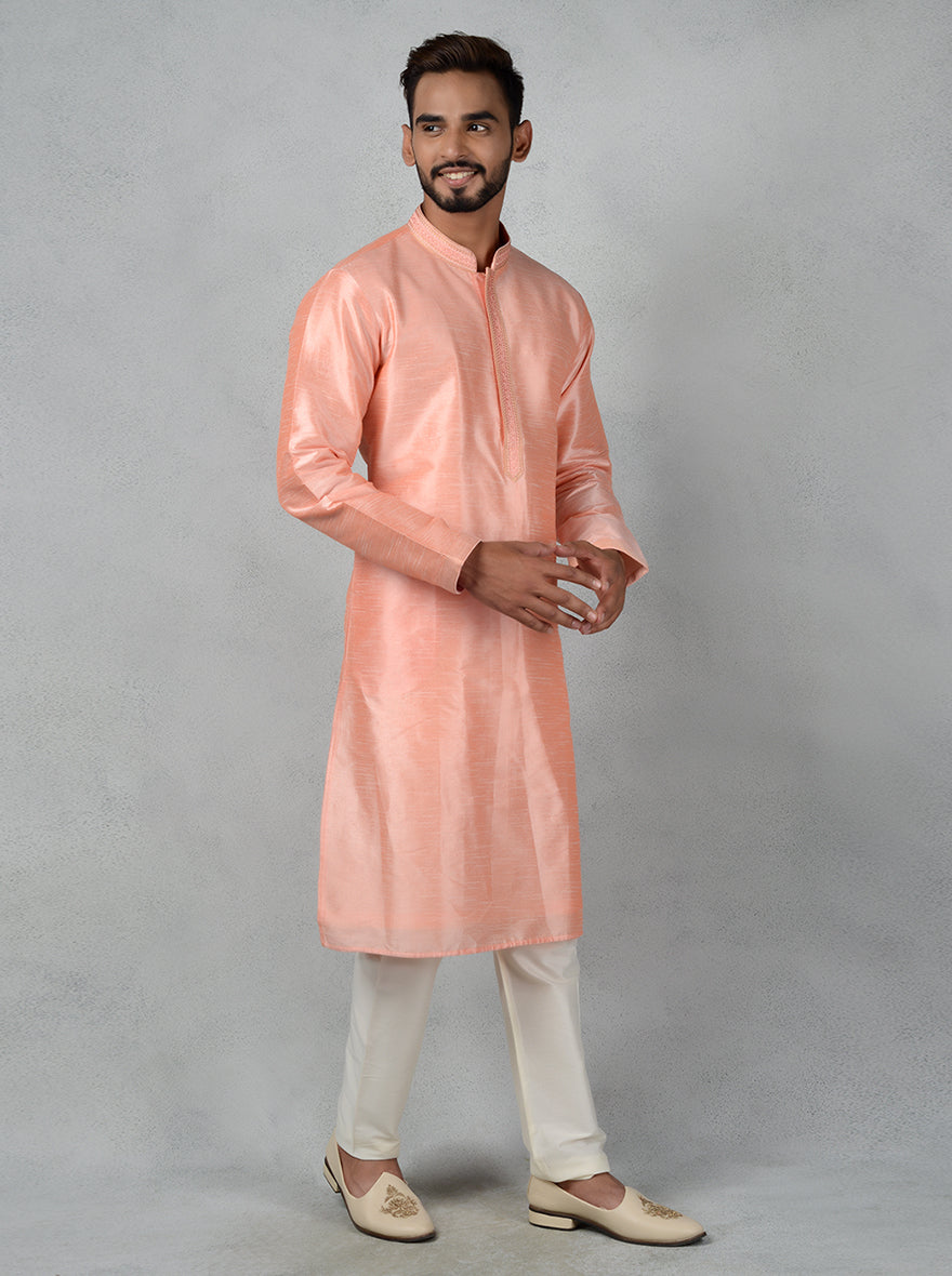 Shine at cultural gatherings in the USA with this embroidered peach kurta pajama for men.