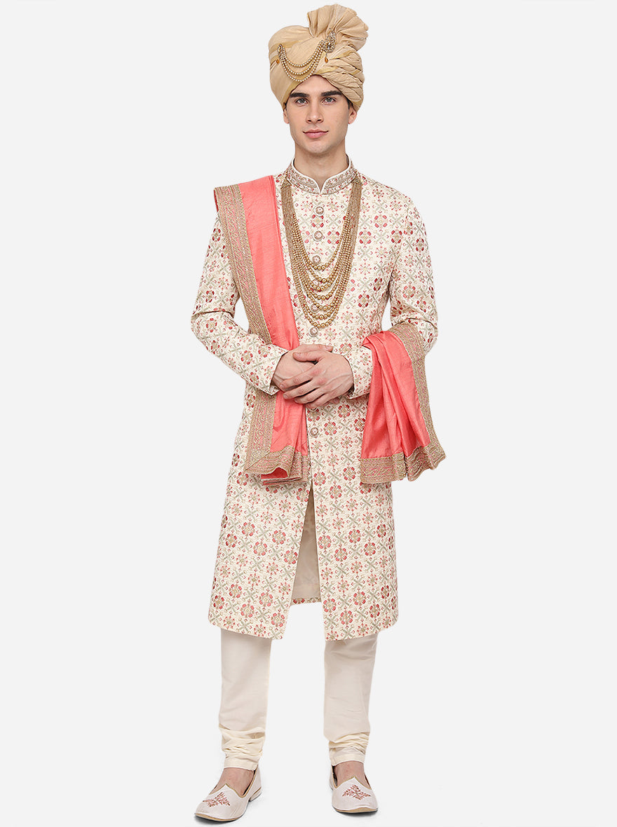 Complete your attire with our cream Sherwani by pairing it with white juttis for a regal look.