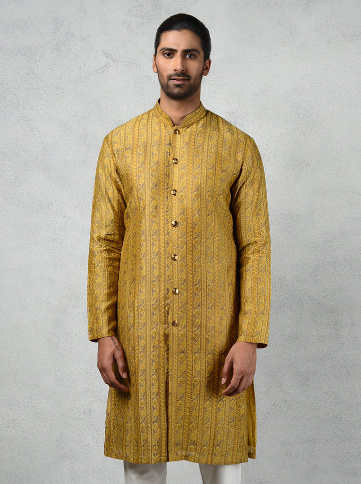 Celebrate in comfort with this mustard tussar silk kurta, ideal for stylish family events.