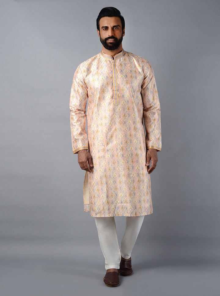 Embrace tradition with a contemporary twist in our elegant peach kurta set.